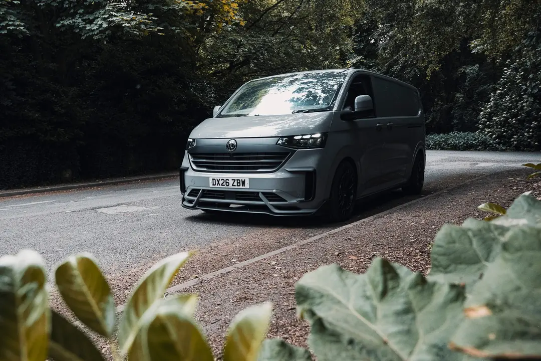 Grey VW Transporter T7 panel van on a woodland road