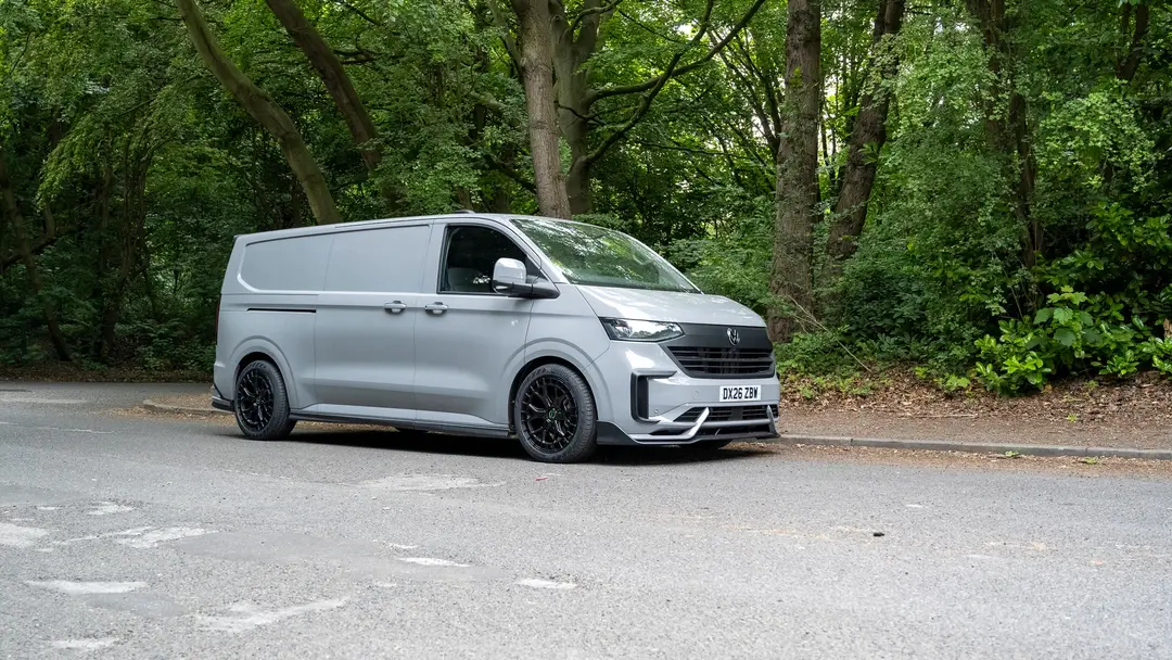 Grey VW Transporter T7 panel van by the trees