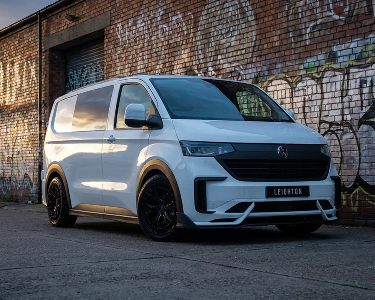 White VW Transporter T7 by a graffiti wall